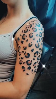 a woman with a leopard print tattoo on her arm