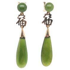 A fine pair of Chinese gold & jade earrings. In 14k yellow gold and green jade (nephrite). From "new" old stock from a jewelry store that closed in the 1970s. Each consisting of a jade teardrop suspended from a jade sphere with gold earbacks. The gold that connects the teardrop and sphere is in the form of the Chinese character 福, which means 'good fortune' and is often used as an auspicious symbol. Simply a wonderful pair of Chinese jade earrings! Date: 20th Century Overall Condition: They are Chinese Gold, Chinese Jewelry, Chinese Jade, Gold And Green, Jade Earrings, Drop Dangle Earrings, Green Jade, Good Fortune, Jade Green