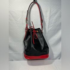 This Bag Is In Great Used Condition, Shows Minor Wear. Black Coated Canvas Bucket Shoulder Bag, Designer Black Bucket Bag For Errands, Red Coated Canvas Shoulder Bag With Detachable Strap, Luxury Red Bucket Bag For Travel, Classic Black Bucket Bag For Errands, Classic Black Bucket Bag For Casual Use, Classic Red Coated Canvas Shoulder Bag, Classic Red Coated Canvas Bag, Black Coated Canvas Bucket Bag