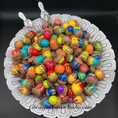 a bowl filled with lots of different colored candies on top of a white plate