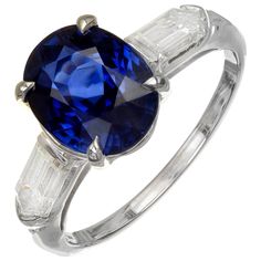 an oval blue sapphire and baguette diamond ring