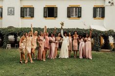 a group of women standing next to each other in front of a building