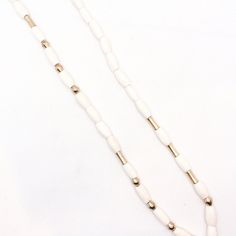 A sleek and elevated version of our most favorite style of necklaces. Perfect to take on that beach vacation. INGREDIENTS: -East African recycled bone beads hand carved by artisans in Kenya -brass oval beads individually fashioned by hand by Ethiopian artisans MEASUREMENTS: -16.5" when worn -tassel is an additional 3" in length CARE: Remove before showering or applying lotion. Avoid oils/perfumes to last. Gently buffer clean with a soft jewelry cloth. Please handle with care as beads can break i White Jewelry With Oval Wooden Beads, Elegant Wooden Beads Jewelry For Beach, Beach Jewelry With Polished Oval Beads, Minimalist Beach Jewelry With Heishi Beads, Elegant Wooden Beaded Necklaces For Beach, Elegant Wooden Beads Necklace For The Beach, Beach Jewelry With Oval Wooden Beads, Artisan Jewelry With Oval Beads For Beach, Artisan Oval Beaded Jewelry For The Beach