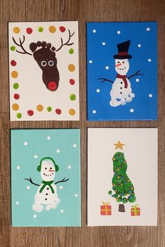 four christmas cards on a wooden table with snowman, reindeer and tree in the middle