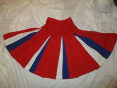 This fun and fabulous red, white and blue skirt is from @ 1950's and I believe a cheerleader skirt. Grab you pom poms and saddle oxfords! There are no labels to indicate maker or size so it was probably hand made. The fabric is a knit, probably polyester, poly blend. Very well made. Box pleated from the hips. Side zip. The original metal zipper works just fine.  I noticed that on the hem the thread color is changed to match the fabric. It measures 25" long from the top of the band. Laying flat s Cheer Skirt Pattern, Cheerleader Skirt, Saddle Oxfords, Pom Pom Girl, Leather Motorcycle Jacket, Box Pleats, Blue Skirt, Metal Zipper, Skirt Pattern