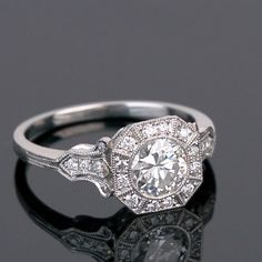 an antique style engagement ring with diamond accents