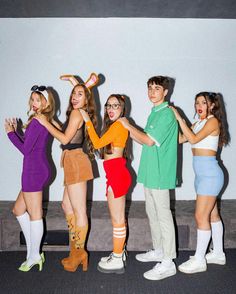 four people dressed up in costumes posing for a photo with one person wearing bunny ears