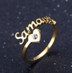 "Description:-  It will make you exciting to see your or your loved once name on this jewelry. Material: Stainless steel Plating: 18K Silver or Gold or Rose Gold Ring Size:- 7, 8, 9, 10 GEM:- Cubic Zirconia If you want Solid Rose gold, Gold or Yellow Gold, let us know we can also make that for you on request.  → [How to process the order] 1. Please tell us the name and Font Number in the 'Personalization Box' Above For Example- Jennifer + Font 1 Note: if you do not choose a font, we will make font#2 for you. and select the finish, Size, etc from the menu option. 2. Now, click on \"Pay with Paypal\" OR \"Add to basket\" . At the checkout page, you can choose to either pay with your PayPal account or you can pay with a \"credit/debit card\". 3.If you have a special request like a gift messag Customizable Nameplate Jewelry For Promise, Personalized Heart Ring For Valentine's Day Promise, Personalized Heart Promise Ring For Valentine's Day, Stainless Steel Rings For Valentine's Day Anniversary, Personalized Heart Ring For Valentine's Day, Personalized Adjustable Heart Cut Ring, Personalized Gold Heart Ring For Anniversary, Personalized Yellow Gold Heart Ring For Promise, Personalized Adjustable Heart Ring For Valentine's Day