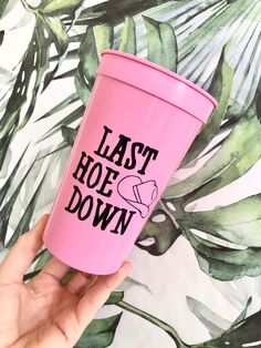 a person holding a pink tumbler with the words last hope down on it