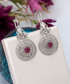 Ruby Corundum Dangle Silver Earrings Boho, 925 Sterling Gemstone Earrings Artisan Made Filigree Dream Catcher Earrings, Women Handmade Jewelry Drop Earrings Handcrafted Earrings Material: 925 Sterling Silver ( NICKEL FREE ) Length and Width: 4.8cm X 2.2cm // 1.9 Inch X 0.86 Inch Gemstone: Ruby Corundum 6mm. FREE, FAST AND TRACKABLE SHIPPING FOR ALL EU COUNTRIES AND USA. They have a circle shape which called dream catcher jewels and has a stunning ribbon top of the earrings that add the perfect s Fusion Style White Gold Earrings For Gift, Silver Fusion Earrings, Silver Fusion Style Danglers For Gift, Artisan Silver Pendant Earrings, Fusion Style Sterling Silver Danglers, Silver Fusion Danglers For Gift, Elegant Sterling Silver Danglers As Gift, Elegant Sterling Silver Danglers For Gift, Silver Ruby Earrings As Gift