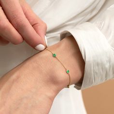 Tanya Add a touch of verdant magic to your wrist with the Emerald Station Bracelet, a celebration of the May birthstone. This enchanting piece features a chain of vibrant emeralds, catching the light like dewdrops on leaves. The gleaming gold setting complements the emeralds' natural beauty, creating a timeless and elegant design. - Handmade- Solid Gold- Natural Emerald - Total Emerald Carat Weight: 0.60 ctw- 5 Emerald Bezels: 0.12 ctw each- Size of Bezel: 5 mm All pieces come beautifully boxed in suede pouches you can always use when traveling! Yellow Gold May Birthstone Bracelets For Anniversary, Yellow Gold Bracelets For Anniversary, May Birthstone, Yellow Gold Jubilee Bracelet With May Birthstone, Yellow Gold Jubilee Bracelet, May Birthstone, Yellow Gold Jubilee Bracelet For May Birthstone, Fine Jewelry Green Diamond Bracelet In 14k Gold, Emerald Bracelets For Anniversary, May Birthstone, Fine Jewelry 14k Gold Green Diamond Bracelet, Fine Jewelry Diamond Bracelet For May Birthstone