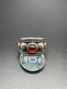 "Vintage James Avery Garnet ring.  Size Sterling Silver.  This is an estate piece and was not polished to protec the patina.  It can be cleaned if you prefer the \"shiny\" silver, but the patena will return with wear as this is sterling silver.  Very little wear, client estimated purchased in 1980s. It can be sized for an additional fee, just message me for details.  Please ask questions before you buy.  We reply promptly." Silver Heirloom Dome Ring, Round Shape, Heirloom Silver Dome Ring, Vintage Sterling Silver Wide Band Ring, Silver Heirloom Ring With Cabochon, Silver Heirloom Cabochon Rings, Vintage Wide Band Ring Stamped 925, Silver Heirloom Dome Ring, Vintage Stamped 925 Dome Ring, Unique Silver Ruby Ring With Polished Finish