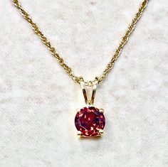 14K Gold Garnet Pendant Necklace - Solid 14K Yellow Gold Garnet Necklace - January Birthstone Necklaces For Women - Birthday Gift For Her Beautiful 14 karat yellow gold pendant necklace featuring a natural 5 mm round garnet, the birthstone for January.  The gemstone weighs approximately 0.60 carat.  The pendant comes with a lightweight 14 karat yellow gold rope chain.  The chain measures 18 inches and is 0.90 mm thick.  Birthstone: January. Condition: Brand New. - 14-day return policy, no questi Round Birthstone Necklace For Celebration, Gold Birthstone Necklace With Prong Setting For Formal Occasions, Round Birthstone Jewelry For Celebration, Hallmarked Round Birthstone Necklace For Anniversary, Round Hallmarked Birthstone Necklace For Anniversary, Gold Birthstone Necklace With Prong Setting As Gift, Gold Birthstone Necklace With Prong Setting For Anniversary, Round Birthstone Necklace With 17 Jewels For Anniversary, Yellow Gold Birthstone Necklace With Prong Setting For Anniversary