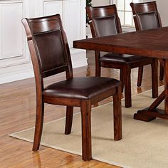 a dining room table with chairs and a rug