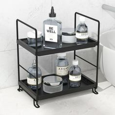 a bathroom shelf with bottles and soaps on it