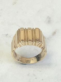 a gold ring sitting on top of a white counter