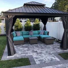 an outdoor living area with couches and a gazebo