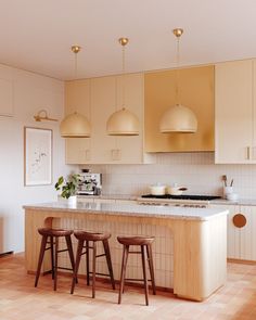 the kitchen is clean and ready to be used for cooking or eating, with three stools at the island