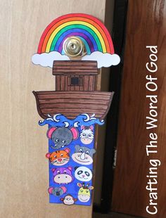 a door hanger made to look like a boat with animals on it and a rainbow in the background