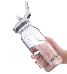 a hand holding a blender bottle with the lid open