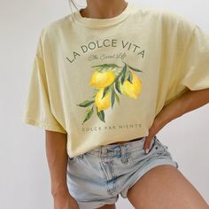 Our Comfort Colors® t-shirt, featuring "La Dolce Vita" with a vibrant lemons graphic, is a perfect blend of Italian charm and preppy style. Ideal for an Italy vacation or adding a citrusy touch to your wardrobe, this lemon shirt captures the essence of Italia and the refreshing spirit of limoncello. Prefer this design on a Sweatshirt? Visit this link: https://bohemianbloomdesigns.etsy.com/listing/1775765095 Prefer this design on a Baby Tee? Visit this link: https://bohemianbloomdesigns.etsy.com/ Casual Cotton T-shirt With Lemon Print, Yellow Printed Crew Neck Shirt, Yellow Short Sleeve Top With Letter Print, Casual Screen Print Shirt For Spring, Casual Spring Shirt With Funny Print, Yellow Printed Cotton Shirt, Casual Short Sleeve Shirt With Funny Print, Yellow Funny Print Crew Neck Top, Casual Lemon Print Tops For Spring