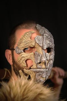 a man with his face painted gold and silver