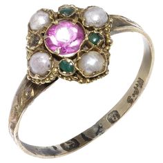 Early Victorian Mid 19th Century 9kt Gold Ring with Pink Sapphire, Pearls, and Emeralds Ring Size: UK Size N (US Size 6 3/4, EU Size 54) Weight: 1 gram Material: 9kt Gold Origin: Mid 19th Century, Victorian Era Hallmarks: Visible but partially worn; detailed examination needed for precise identification. Design: Intricate detailing on the band and setting, showcasing the craftsmanship of the period. Gemstones: Pink Sapphire: Cut: Round Cut Quantity of Pink Sapphires: 1 Total Carat Weight: 0.20 c Bridgerton Jewelry, Victorian Wedding Ring, Pink Pearl Ring, Victorian Romance, Antique Jewelry Rings, Ruby Engagement Ring, Victorian Rings, Rings Diamond, Victorian Jewelry