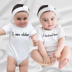 Twins Onesies, Funny Twin Onesies For Babies, Twin Baby Onesies, Twins Outfits Baby, Twins Baby Gift, Twin One Twin Two, Twins Gift The Baby Rib Bodysuit is outstanding as the most basic and comfortably garment for your baby's wardrobe. It will act smoothly and never cause irritation due to its 100% combed ringspun cotton makeup (composition differs by color). - Comprised of 100% combed ringspun cotton, offering a soft and comfortable fabric - Heathers are made with a blend of 90/10 combed ringspun cotton/polyester for a balanced combination of comfort and durability - Granite Heathers feature a blend of 60/40 combed ringspun cotton/polyester, providing a unique and stylish appearance - White bodysuits are sewn using 100% cotton thread, ensuring quality and attention to detail - Light fabr Cute Onesie For Playtime On Mother's Day, Cute White First Birthday Sets, White Sets With Letter Print For Birthday, Customizable White Onesie For Playtime, Playful White Sets For First Birthday, White Cotton Birthday Set, Personalized White Onesie For First Birthday, White Onesie For First Birthday On Mother's Day, White Family Matching Onesie For Playtime