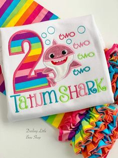 two year old birthday shirt with shark and rainbow ruffles on the bottom, one is