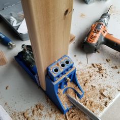 a pair of pliers are on the floor next to a piece of wood