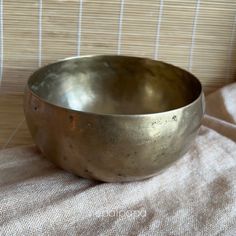 a large metal bowl sitting on top of a table