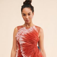 a woman in a red and white dress posing for the camera