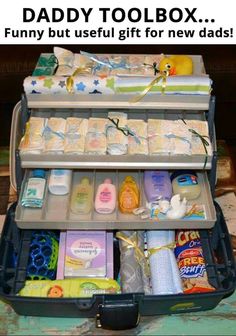 an open suitcase filled with baby items on top of a table