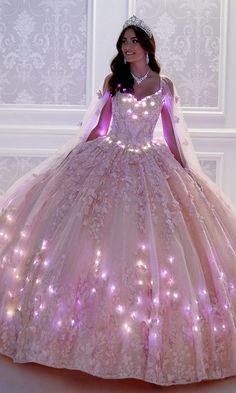 Light up the night in this glow-in-the-dark quinceañera dress from the Princesa by Ariana Vara collection. Matching color lights accent the v-neckline, highlight the waist, and crest in bright waves around the poofy ball-gown-style skirt of this quince dress. While the lights will keep all eyes on you in the low light of an evening dance party, the beading, stone accents, and glitter tulle skirt are sure to dazzle in the spotlight. The beautifully embroidered lace detailing and detachable matchi Colored Lights, Pink Emerald, Dark Dress, Quince Dress, Lace Ball Gowns, Princess Inspired, Prom Girl, Gala Dresses, Designer Gowns