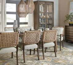 the dining room table is set with beige chairs