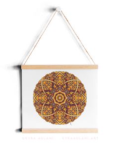 a wooden frame hanging on the wall with an orange and yellow flower design in it