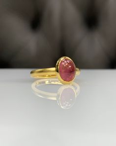 Natural Pink Tourmaline Ring * Dainty Cabachon Ring * Genuine Tourmaline & 14K Solid Gold * Best Gift for Her/Him * Handmade Ring ◎ Details ◎ ○ Gemstone Details .Natural PINK TOURMALINE Oval Cut 9X7 mm approx. 2.09 ct ○ Gold Details 14K Solid Gold Width of Band : 2.50 mm Weight of Ring : approx 3.80 gr Made to Order HANDMADE ITEM ○ Upgrade to Solid 18K Gold, please click the link below: https://www.etsy.com/listing/962826004 For more CABACHON BEZEL rings : http://etsy.me/37fvI60 All of our j Heirloom Gold Tourmaline Ring, Oval Tourmaline Sapphire Ring For Gifts, Gold Oval Tourmaline Ring, Gold Tourmaline Gemstone Rings, Gold Tourmaline Rings, Classic Gold Tourmaline Jewelry, Gold Tourmaline Ring Fine Jewelry, Gold Tourmaline Ring In Fine Jewelry Style, Gold Tourmaline Rings In Fine Jewelry Style