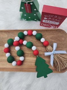 a wooden tray with christmas decorations on it