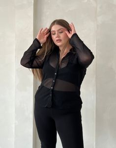 With its sleek and flattering silhouette, the Plus Size Sheer Ribbed Button Up Shirt offers a trending way update to your workwear wardrobe. Wear this plus size sheer top with a cute bralette underneath to give the full effect and a pair of trousers for a street style outfit that's very on trend right now. This top features buttons up the front, long sleeves, a v-shaped neckline, a folded-down collar, and a single chest pocket. The material is a sheer, stretchy knit material. This shirt is made Casual Sheer Top For Office, Chic Stretch Button-up Tops, Casual Long Sleeve Tops With Built-in Bra, Fitted Sheer Shirt For Work, Stretch Tops With Sheer Sleeves For Work, Fitted Sheer Shirt For Workwear, Sheer Fitted Button-up Shirt, Fitted Sheer Button-up Shirt, Casual Sheer Blouse For Office