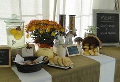 there is a table with food on it and some signs in front of the table