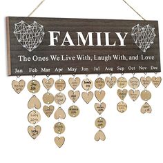 a wooden sign with hearts hanging from it's sides and the words family on it