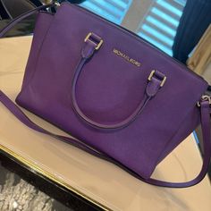 Michael Kors Purple Leather Medium Selma Satchel Crossbody Bag Used Just 2 Times Perfect Condition O Purple Saffiano Leather O Logo Interior O Gold-Tone Hardware O Detachable Adjustable Shoulder Strap O Top Zip Closure O 2 Interior Slip Pockets And 1 Zip Pocket Dust Bag Not Included Classic Purple Evening Bag, Classic Purple Bag With Detachable Handle, Luxury Purple Shoulder Bag With Adjustable Strap, Classic Purple Shoulder Bag With Detachable Handle, Purple Shoulder Bag With Gold-tone Hardware For Shopping, Classic Purple Top Handle Bag, Designer Purple Double Handle Shoulder Bag, Luxury Purple Shoulder Bag With Detachable Strap, Luxury Purple Bags With Double Handle