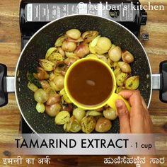 someone is holding a cup in front of some food on a plate with the words tamarid extract 1 cup