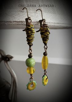 Art Jewelry 'Sun Pod Dangle Earrings'  Pure aged brass wire, multicolored Lampwork beads, recycled sari silk pods. Antique Brass Lever ear wires. Shoulder duster length: approximate 3" long Sunny and beautiful! Cheldena ArtWear™ --'"".--'""-- Handmade Adjustable Green Wrap Earrings, Adjustable Handmade Green Wrap Earrings, Adjustable Nickel-free Beaded Artsy Earrings, Adjustable Nickel-free Artsy Beaded Earrings, Artisan Multicolor Wire Wrapped Earrings, Handmade Adjustable Artsy Beaded Earrings, Bohemian Glass Beaded Earrings With Ear Wire, Artsy Adjustable Nickel-free Beaded Earrings, Handmade Artsy Beaded Earrings