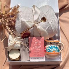 an open box containing candles, soaps and other items