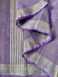 Bring your lavender dreams into reality with this Lavender & Silver Zari tissue linen  Plain Shimmer Saree. This saree is elegance overloaded. You can get so many different looks just by switching blouses.  Saree Length 5.5m.  Saree comes with falls & picot/edges done.  Saree comes with Stitched matching blouse which can be selected from Options.  Blouse is available in Sizes 34, 36, 38. Blouse has short sleeves, back opening hooks, high quality lining, tassels & ties . No padding.  Choose size Elegant Lavender Dupatta For Festive Occasions, Elegant Lavender Dupatta With Zari Work, Elegant Lavender Dupatta Traditional Drape, Elegant Lavender Dupatta With Cutdana, Elegant Lavender Cutdana Dupatta, Elegant Lavender Saree With Cutdana, Elegant Lavender Saree With Dupatta, Elegant Lavender Saree For Diwali, Elegant Lavender Saree For Festive Occasions