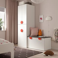 a child's bedroom with pink and white furniture