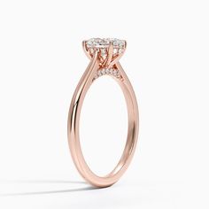 Oval Shaped Dawn Diamond Engagement Ring - 14K Rose Gold. This stunning ring features a petite band that sweeps up to embrace the gemstone in delicate claw prongs. Diamond accents adorn the gallery wire and bridge adding a unique touch to a classic look (1/10 total carat weight). 
 
 Our perfect fit engagement rings are carefully designed to sit flush against a variety of wedding rings for a seamless look with no gaps. Luxury 14k Rose Gold Wedding Ring With Center Stone, Luxury 14k Rose Gold Halo Setting Rings, Luxury 14k Rose Gold Rings With Halo Setting, Luxury 14k Rose Gold Oval Rings, 14k Rose Gold Brilliant Cut Cluster Ring, Luxury Rose Gold Cluster Ring With Brilliant Cut, Formal 14k Rose Gold Ring With Prong Setting, Timeless 14k Rose Gold Promise Ring, Timeless 14k Rose Gold Diamond Ring With Round Cut