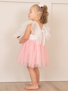 This sweet Pink & White Flutter Tulle Dress will have your little girl twirling with joy! Designed specially for MNC, the delicate flutter sleeves and lined tulle skirt add a whimsical touch, while the delicate lace bodice adds a fun and glamorous element. Perfect for any special occasion, this dress will make your little one feel like a princess! Fits true to size. 97% Cotton / 3% Spandex Accessories sold separately. Suggest bow color #1 and #32 Import. Functional tie on back of dress. Aurora i Whimsical Tulle Fairy Dress With Ruffles, Cute Tulle Fairy Dress With Ruffles, Princess Style Tulle Fairy Dress With Ruffles, Princess Style Fairy Dress With Ruffles, Tulle Dress With Flutter Sleeves For Dress-up, Tulle Dress With Flutter Sleeves For Party, Whimsical Ruffled Tutu Dress For Pageant, Whimsical Ruffled Tutu Dress For Pageants, Cute Tulle Princess Dress With Ruffles