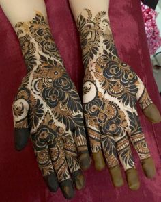 two hands that are decorated with henna designs on the left and right hand,